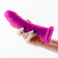 Photo of a hand holding the Colours Girth Dildo (7in, purple) from NS Novelties to show its ergonomic shape and size by comparison.