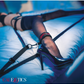 Ad for the Scandal Over the Bed Cross Restraints from CalExotics shows a woman's foot in one of the restraints.