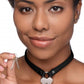Woman wearing the collar (black version) and holding the two keys.
