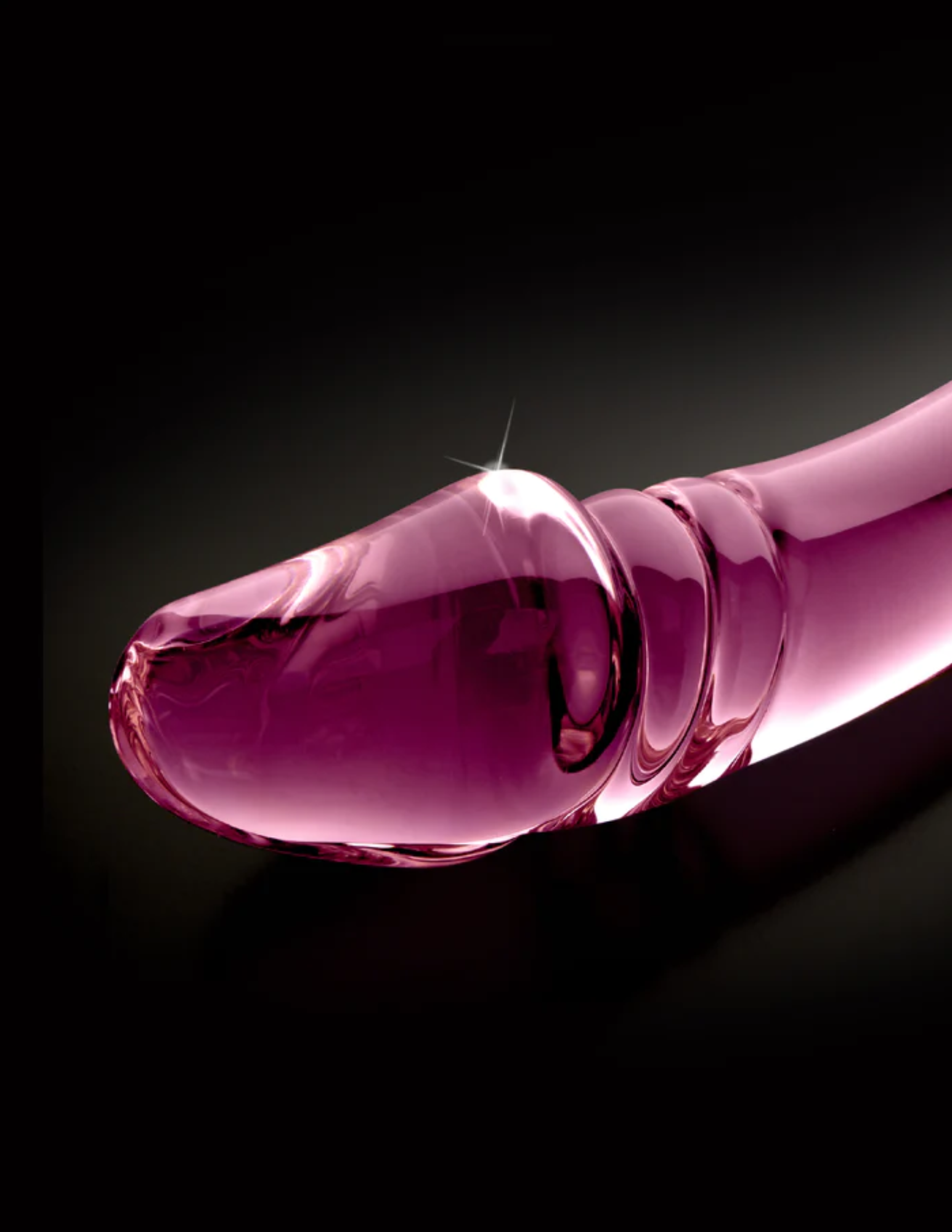 Close-up of the realistic head on the Icicles No. 57 Double-Sided Textured Glass Dildo from Pipedreams (pink).