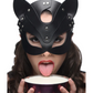 Photo of a woman wearing the mask and seemingly lapping milk out of a bowl that she is holding.