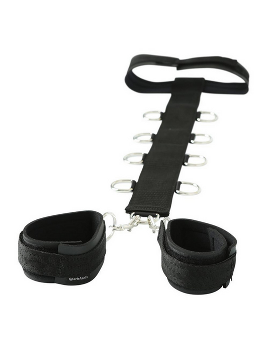 Side angle view of the restraint system, showing each of the D-rings and collar, as well as detachable cuffs.
