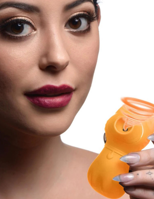 Ad shows a woman holding the Shegasm Sucky Kitty Clitoral Stimulator from XR Brands (orange) showing its suction ability.