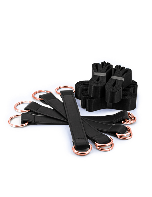 Image shows the buckles and strap bundles that come with the Bondage Couture Tie Down Straps from NS Novelties (black).