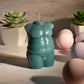 Photo ad for the LaCire Torso Candle from Sportsheets (form 2/green).
