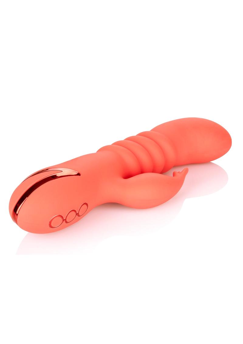 Back side angle of the toy shows its clitoral stimulator and thrusting shaft.