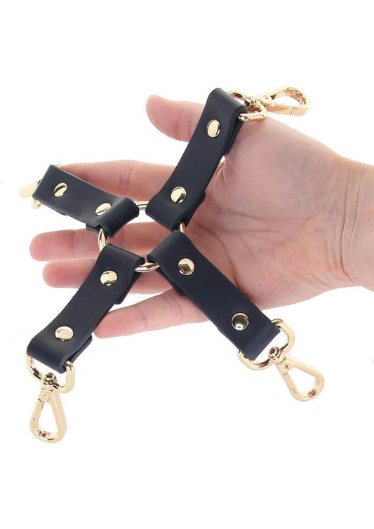 Photo of a hand holding the Bondage Couture Hog Tie from NS Novelties (blue).