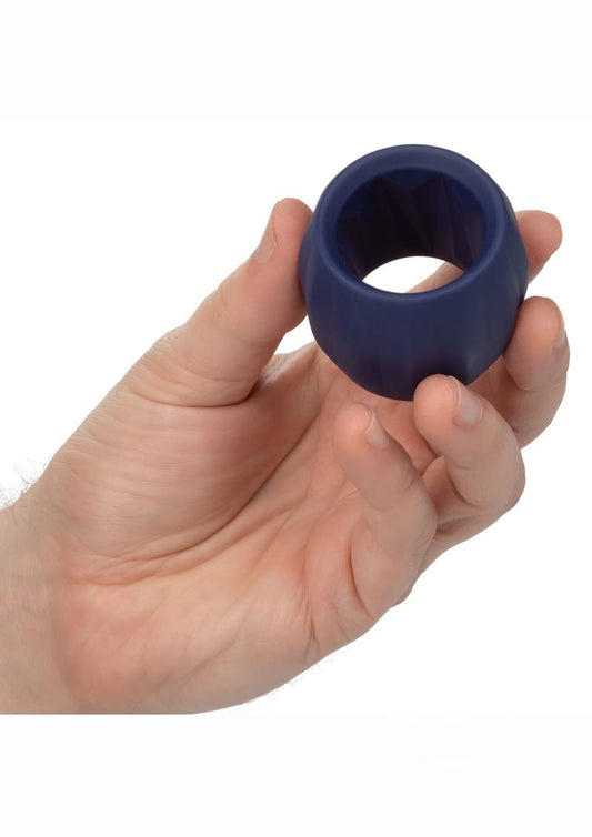 Photo of a hand holding the Viceroy Reverse Stamina Cock Ring from CalExotics (blue) shows its size by comparison.