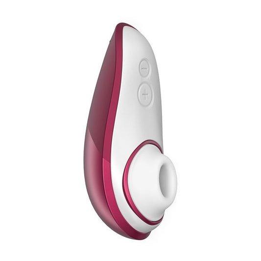 Up-right side view of the toy showing its ergonomic shape and clitoral tip and power control buttons  (red wine).