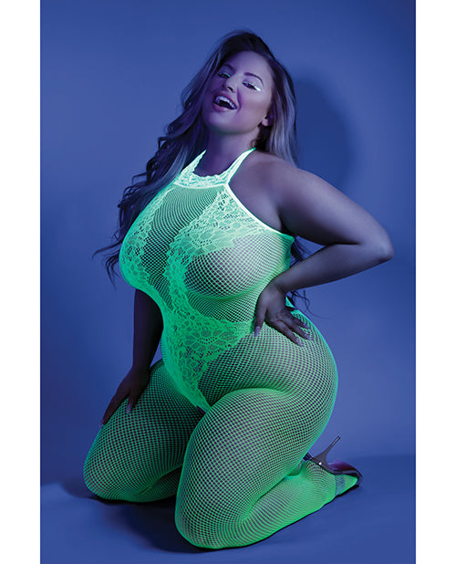 Photo of a woman in a black light room wearing neon green bodystocking (queen).