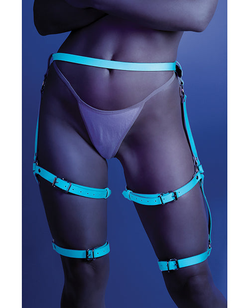 Photo of a model wearing the Glow Buckle Up Glow in the dark Leg Harness (light blue) by Fantasy Lingerie (panties not included).