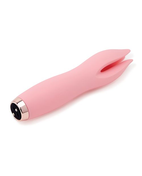 Side angle view of the toy shows its petal like tips and magnetic charging ports (pink).