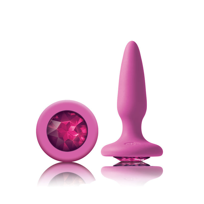Photo of the Glams Mini Silicone Butt Plug from NS Novelties (pink/pink), shows the large gem on the base and the tapered shape of the plug.