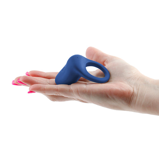 Photo of a hand holding the Inya Regal Vibrating Cock Ring from NS Novelties (blue) to show its size by comparison.