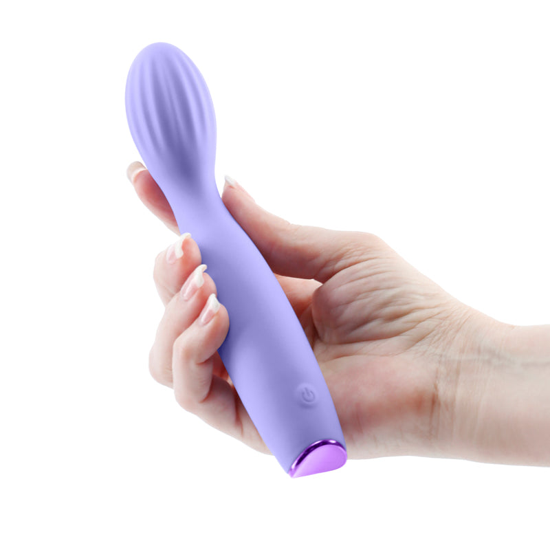 Photo of a hand holding the Revel Pixie G-Spot Vibrator from NS Novelties (purple) shows its slim design and petite shape.