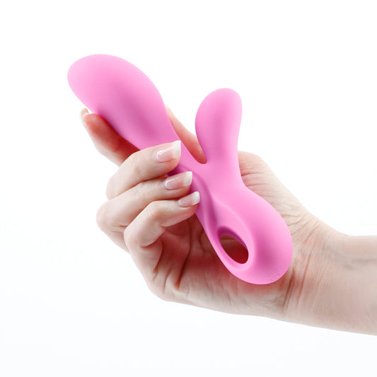 Photo of a hand holding the Revel Galaxy Rabbit Vibrator from NS Novelties (pink) shows its ergonomic shape and size by comparison.