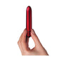Photo of a hand holding the Truly Yours Scarlet Vibrator from Rocks Off (red) shows its size by comparison.
