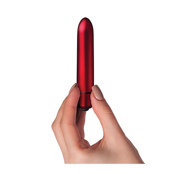 Photo of a hand holding the Truly Yours Scarlet Vibrator from Rocks Off (red) shows its size by comparison.