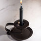 Photo ad of the black candle in candle holder.