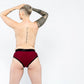 Photo of the back of a person wearing the harness briefs to show the fit and coverage (red).