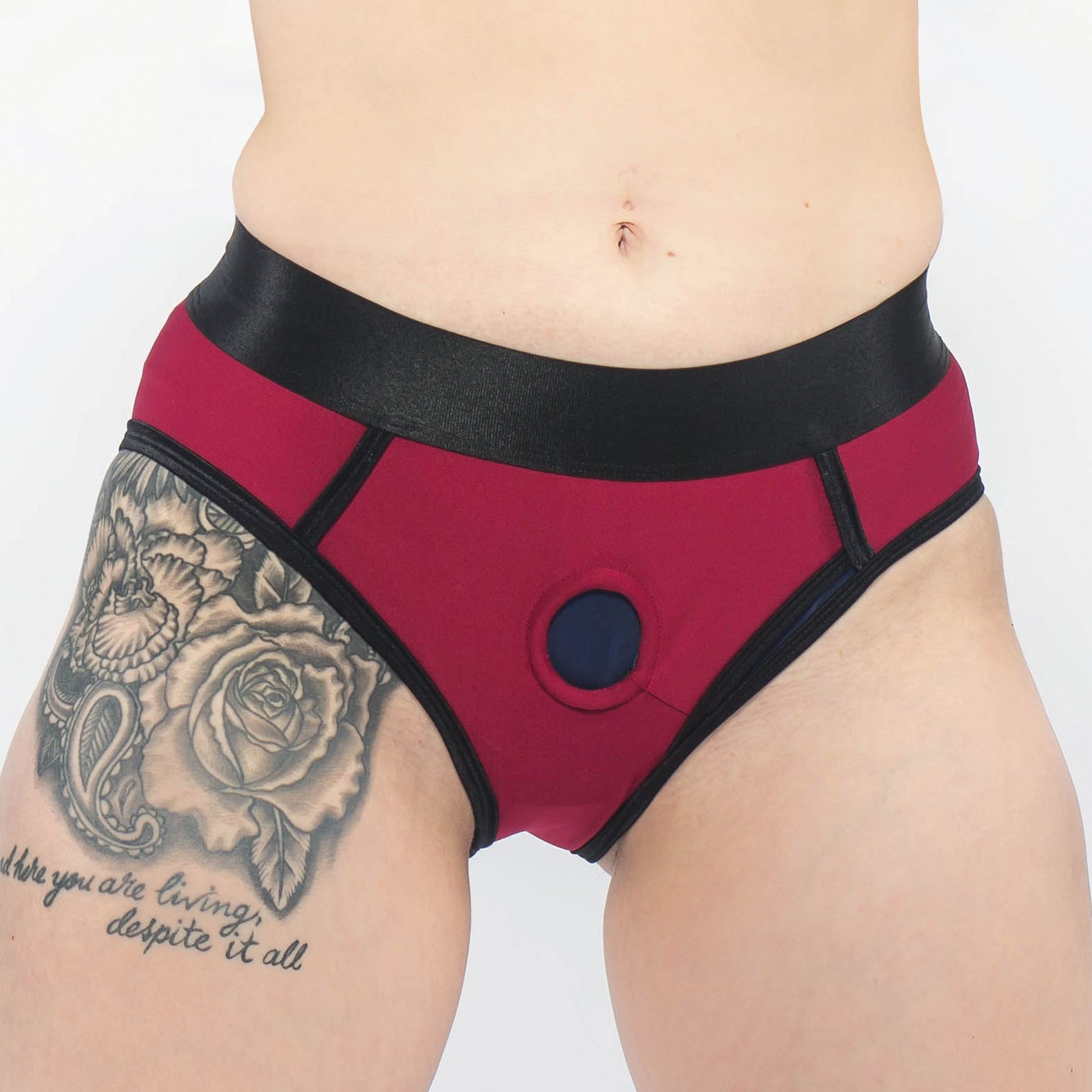 Close-up of a person wearing the harness briefs, front view (red).