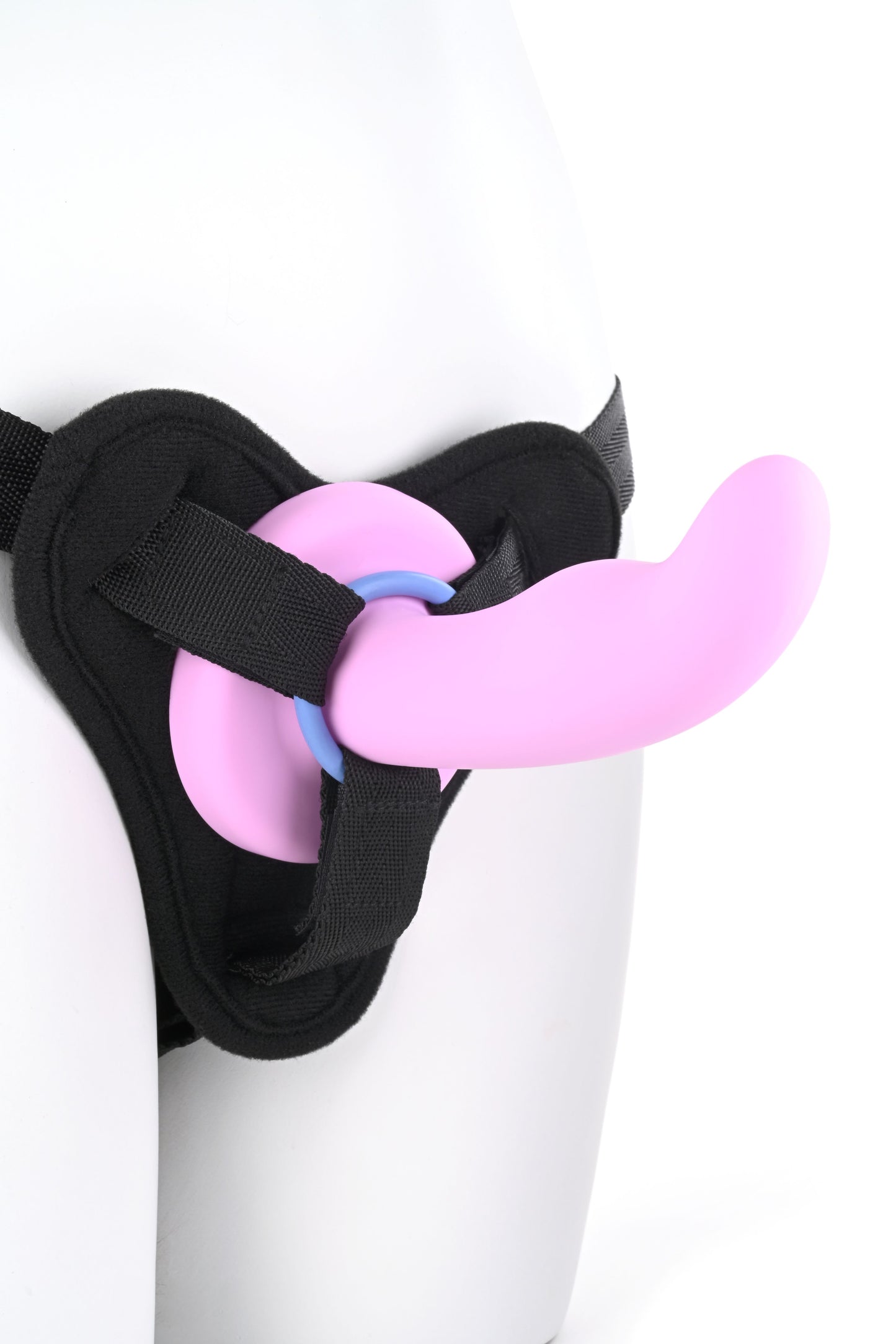 Close-up of the bottom portion of a mannequin wearing a harness with a dildo and using one of the O-rings (periwinkle).