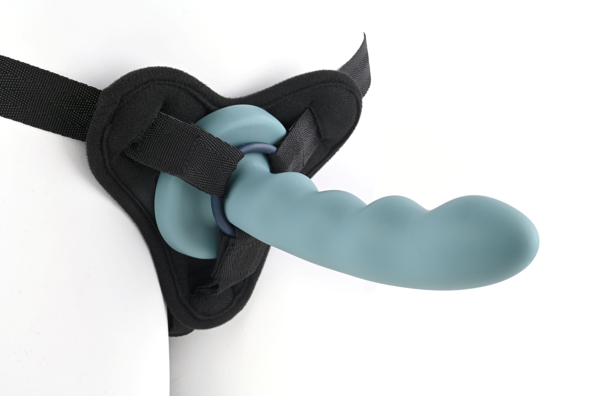 Close-up of a harness and dildo combination with one of the O-rings (navy).