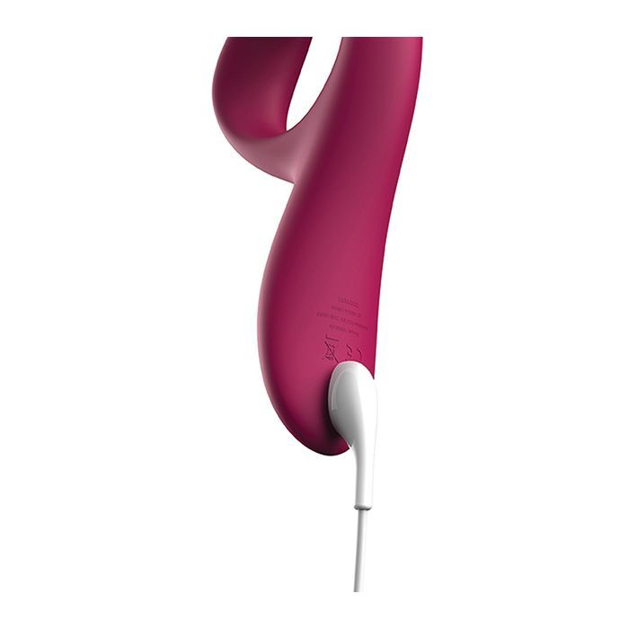 Close-up of the charging pins of the vibrator with the magnetic USB charging cord attached showing the user how to recharge the toy.