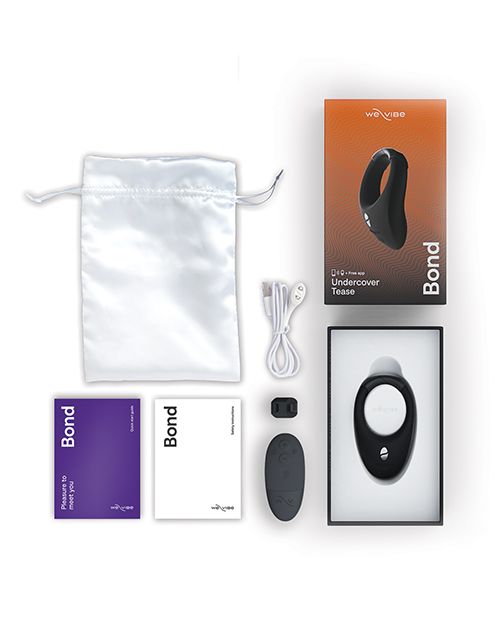 Photo of what is included in the Bond kit: satin storage bag, instruction manual, remote control, extension piece, USB charging cord, cock ring and box. 