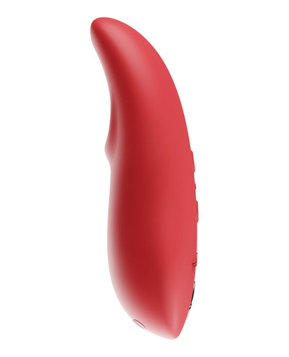 Side view of the toy showing its unique curve and scoop shaped tip for a snug fit at the clitoris (coral).