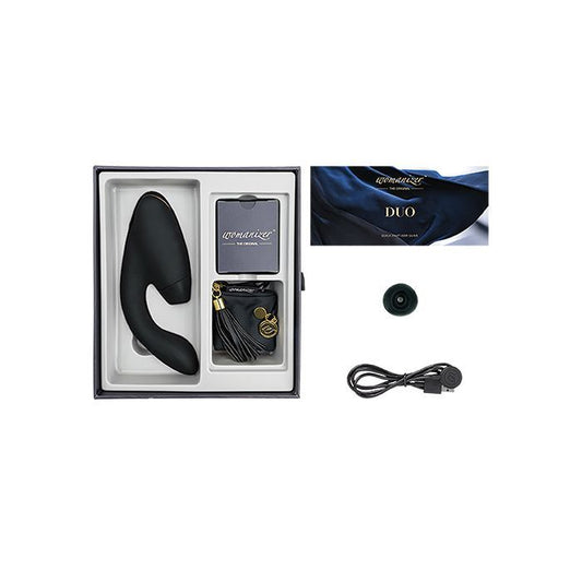 Image shows what is included in the Womanizer Duo kit: toy, USB charging cord, satin and tassel storage bag, replacement clitoral tip, instructions (black).