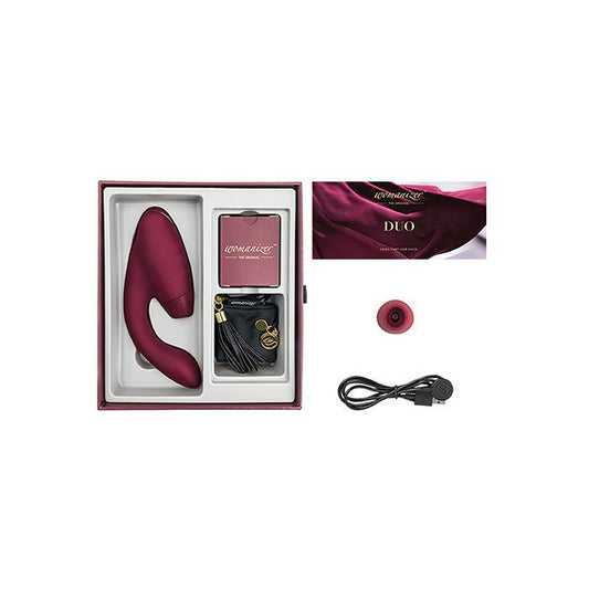 Image shows what is included in the Womanizer Duo kit: toy, USB charging cord, satin and tassel storage bag, replacement clitoral tip, instructions (bordueax).