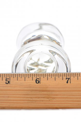The base of the plug next to a ruler to show its width of 2in.