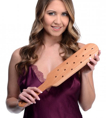 Photo of a woman holding the paddle.