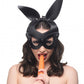 Woman wearing the bunny mask and eating a carrot.