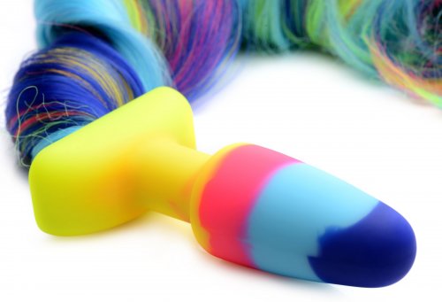 Close-up of the multicolored butt plug and portion of the unicorn tail hair.