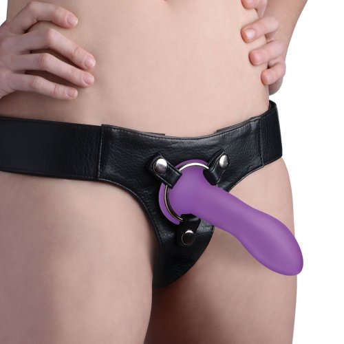 Photo of a body wearing a harness with the dildo attached (purple).