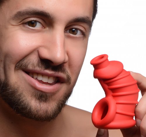Photo of a smiling man holding the cock cage.