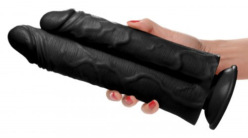Hand holding the "black" version of this double stuffer dildo.