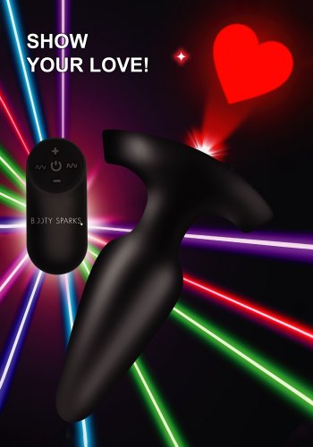 Image of the butt plug shining the red laser heart image on a black and color laser background. Image also shows the remote and says "Show Your Love".