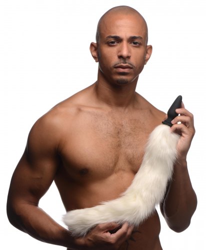 Photo of a man holding the long white fox tail attached to the butt plug base.