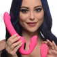 Woman holding the toy up-right and to the side. Wavy lines are drawn along the side of the vibrating bulb and dildo. She holds the remote in the other hand,