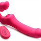Side angle view of the toy so that one can all of the contours as well as the tip of the dildo. The remote is next to the toy.