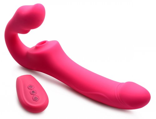 Side angle view of the toy so that one can all of the contours as well as the tip of the dildo. The remote is next to the toy.