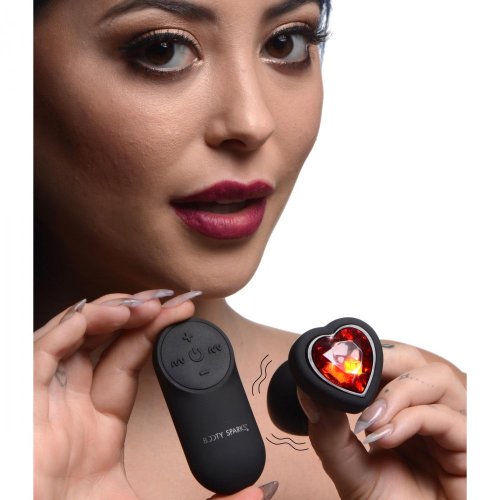 Woman holding the products with small wavy lines around the plug to show that it is a vibrating toy.