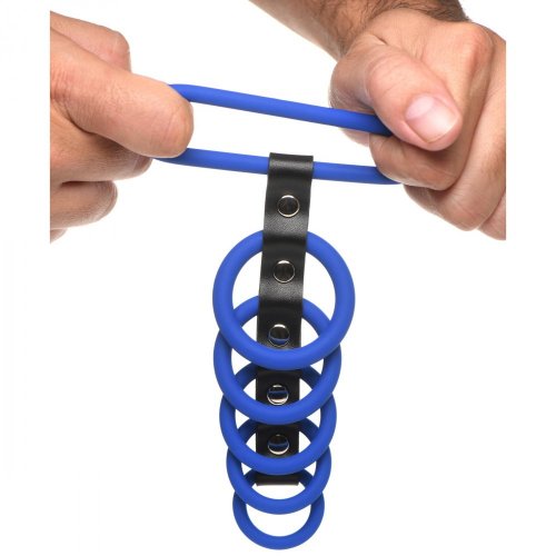 Photo of a man holding the device and stretch the largest ring to show its potential width.