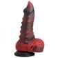 Up-right side view of the dildo showing the texture of the testicles, the nubs up the side, and the curved to pointed tip of the head of the toy.
