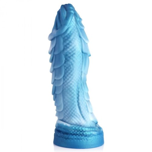 Up-right side angle view of the dildo that shows its curve and smaller scale size on the sides, as opposed to the larger scale ridges on the top and bottom.